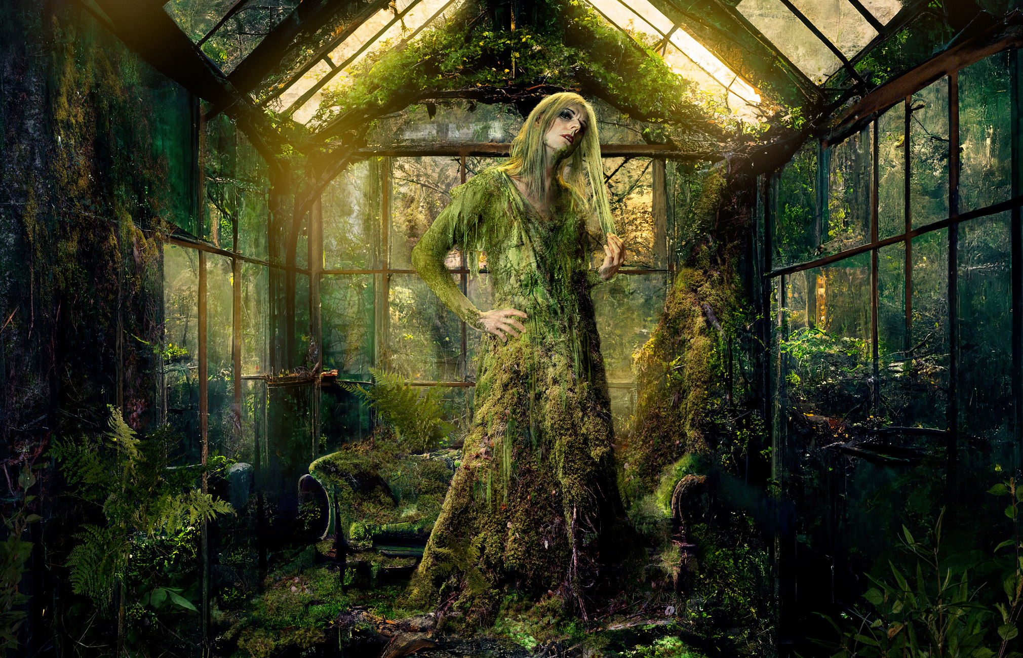 A mysterious and enchanting scene. At the center stands a figure dressed in a gown made from moss and plants. The person is located in an abandoned and decaying greenhouse, which is covered in greenery.