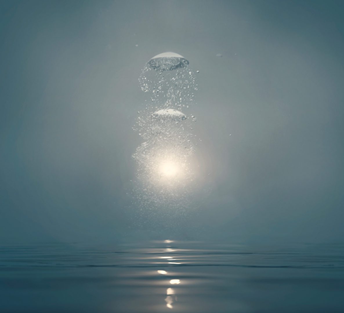 The moment when a water drop hits a calm water surface. A splash is created by the impact, with small water droplets spreading upwards. There is a bright light source behind the splash, illuminating the droplets and creating a glowing effect. The surrounding environment is calm and peaceful with subdued colors, which highlights the brightness of the light source. The light's reflection on the water surface creates a path leading to the splash.